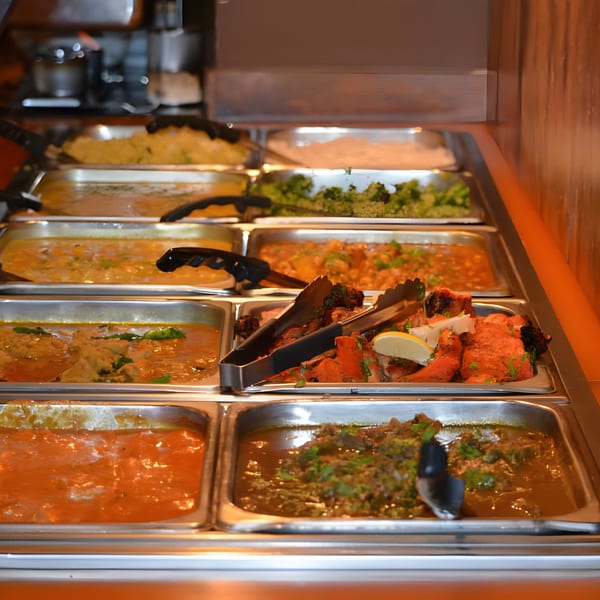 Aditi Indian Dining buffet with various Indian dishes, including curries, rice, and tandoori chicken.